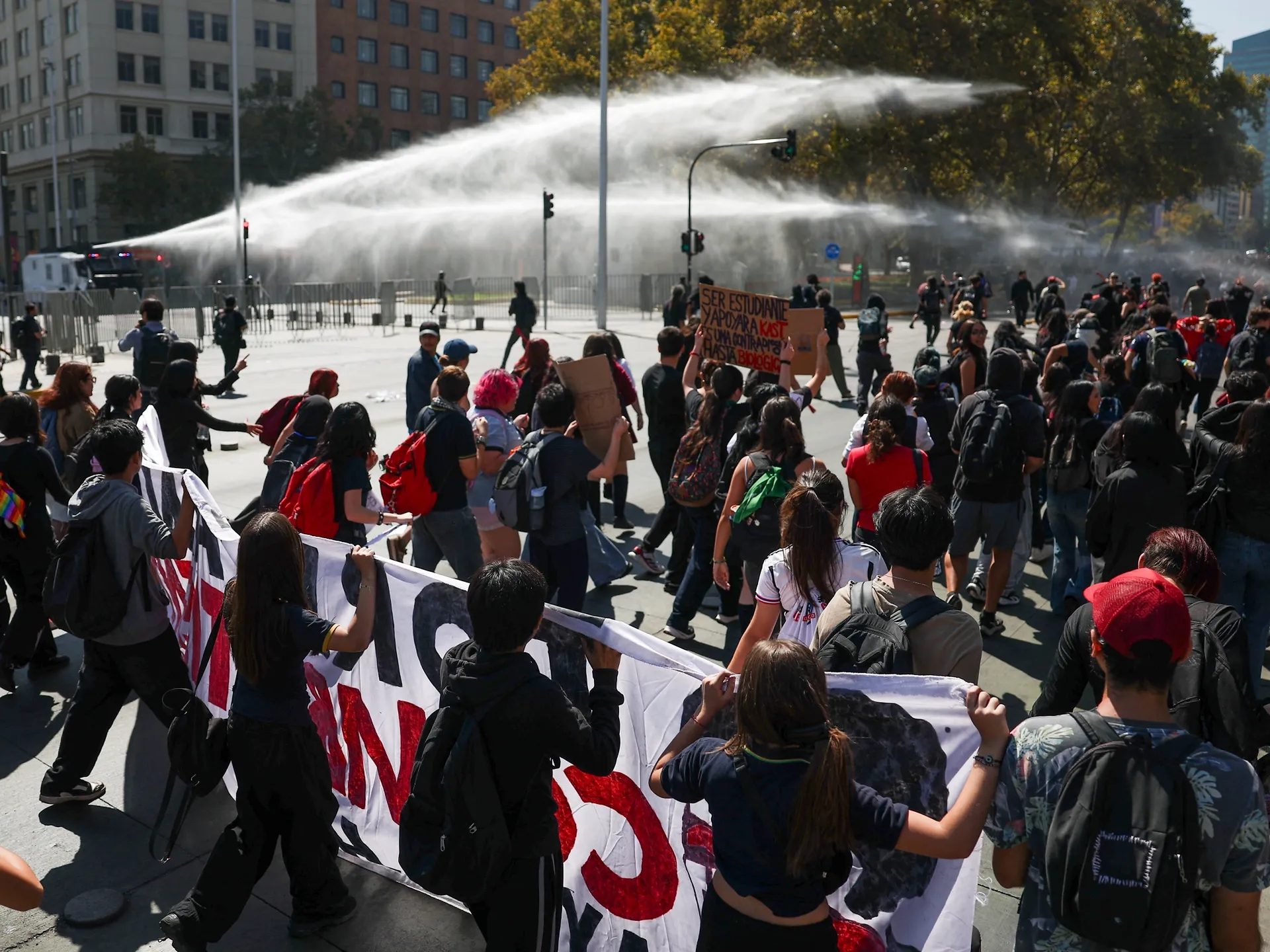 Global Health and Education Watch: Police fire water cannons at Chile student protest